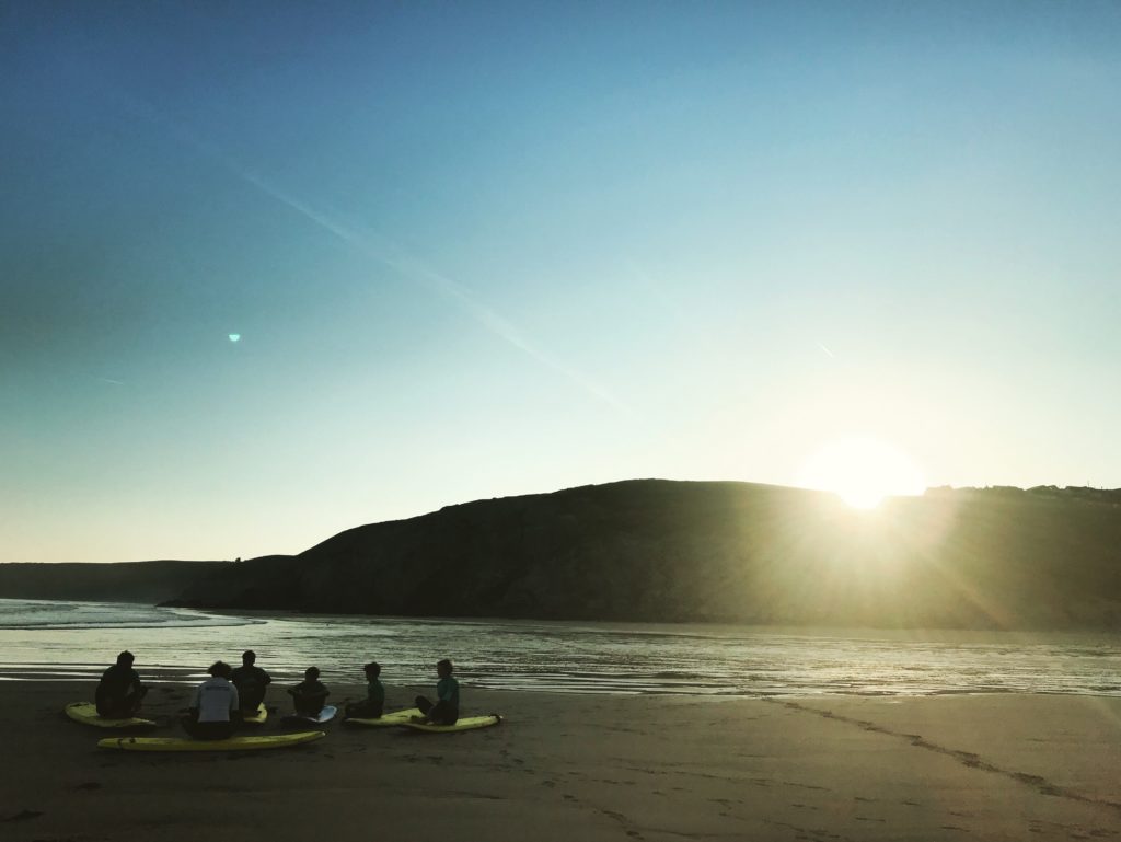 Sunset at St Agnes with a few surfers.